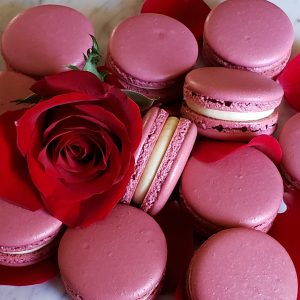 Rose colored macarons with a rose flower
